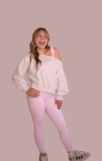 Pink gingham pajama set: loose off-shoulder sweatshirt and check leggings, full front view